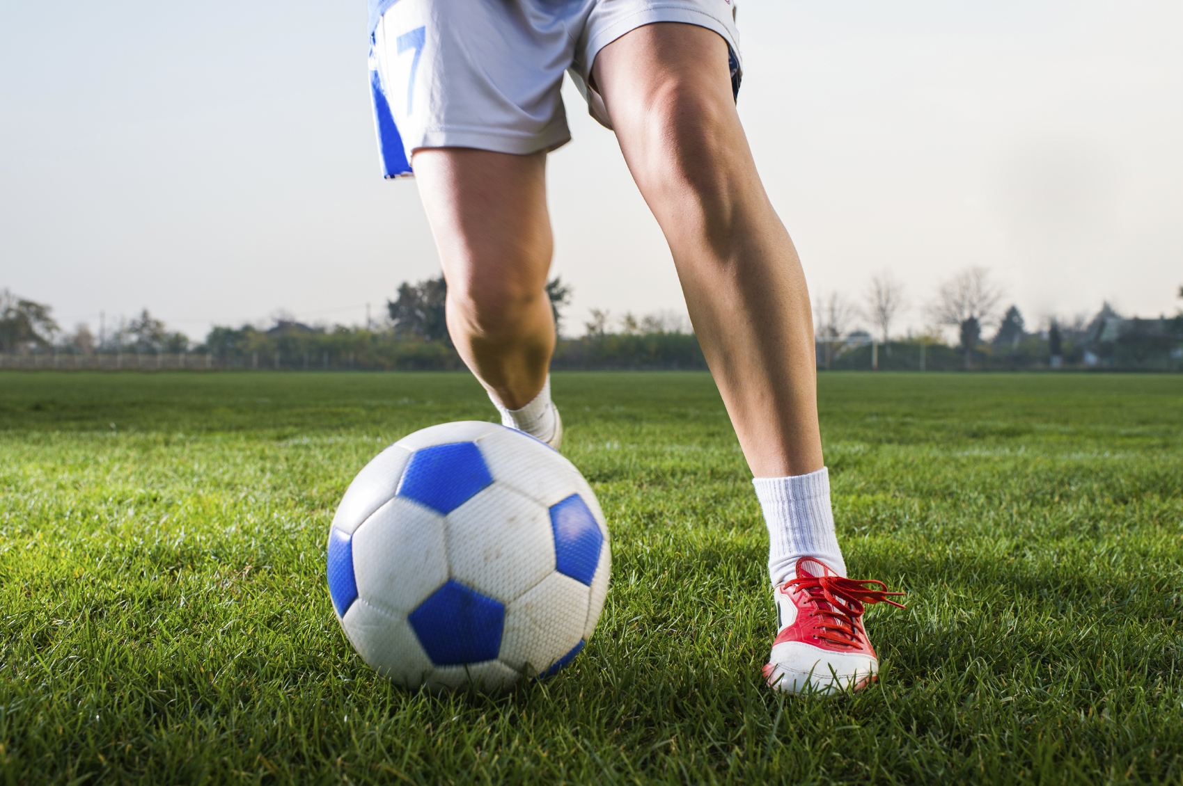 young girl kicking soccer ball on field | Electronic World TV Blog