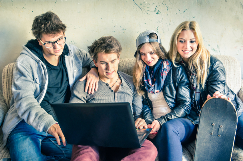 Group of young hipster best friends with computer in urban alter