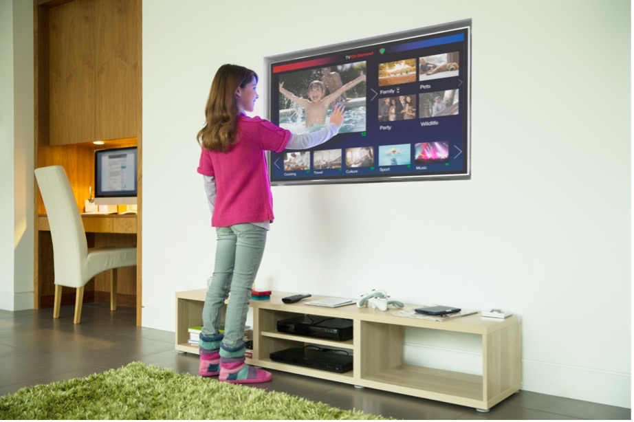 A person standing in front of a television