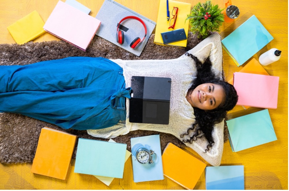 A person lying on the floor with a tablet