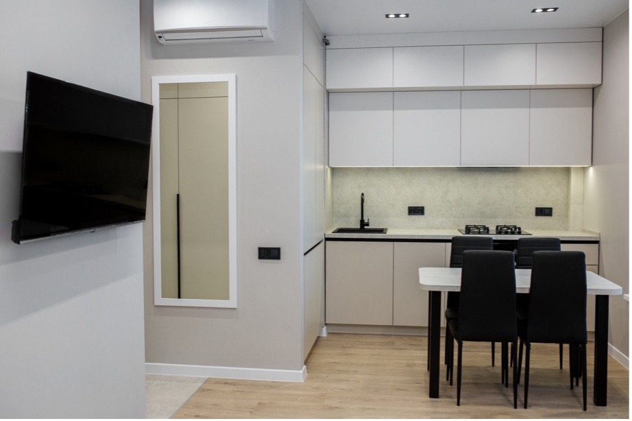 A kitchen with a table and chairs