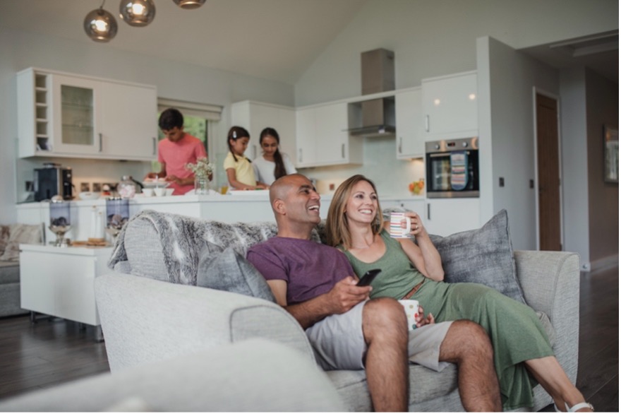 A person and person sitting on a couch