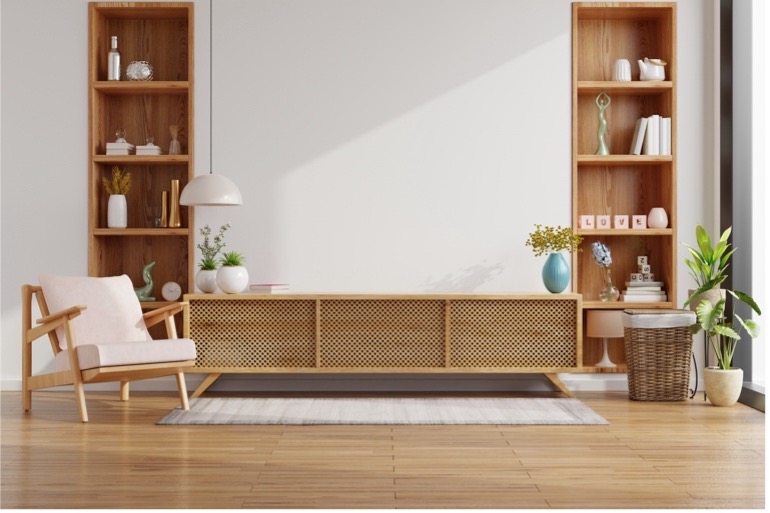 A living room with a white wall and shelves